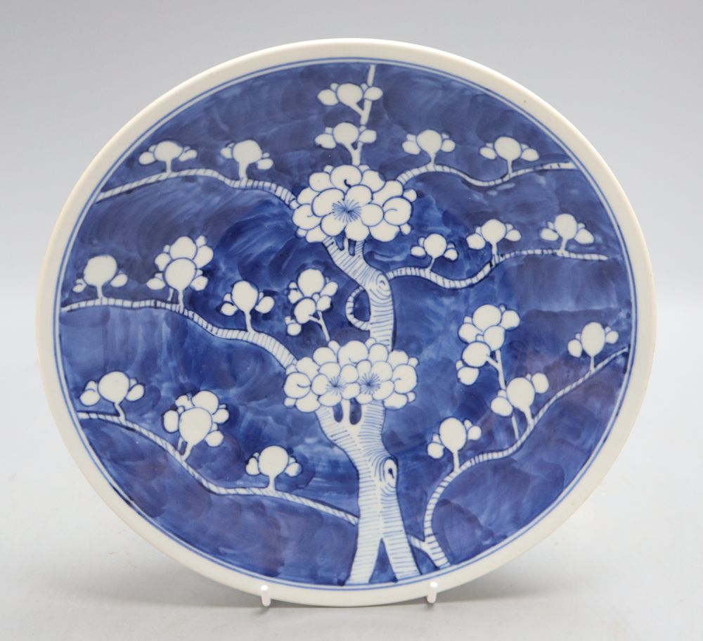 A 19th century Chinese blue and white prunus pattern dish, Kangxi mark, diameter 27cm